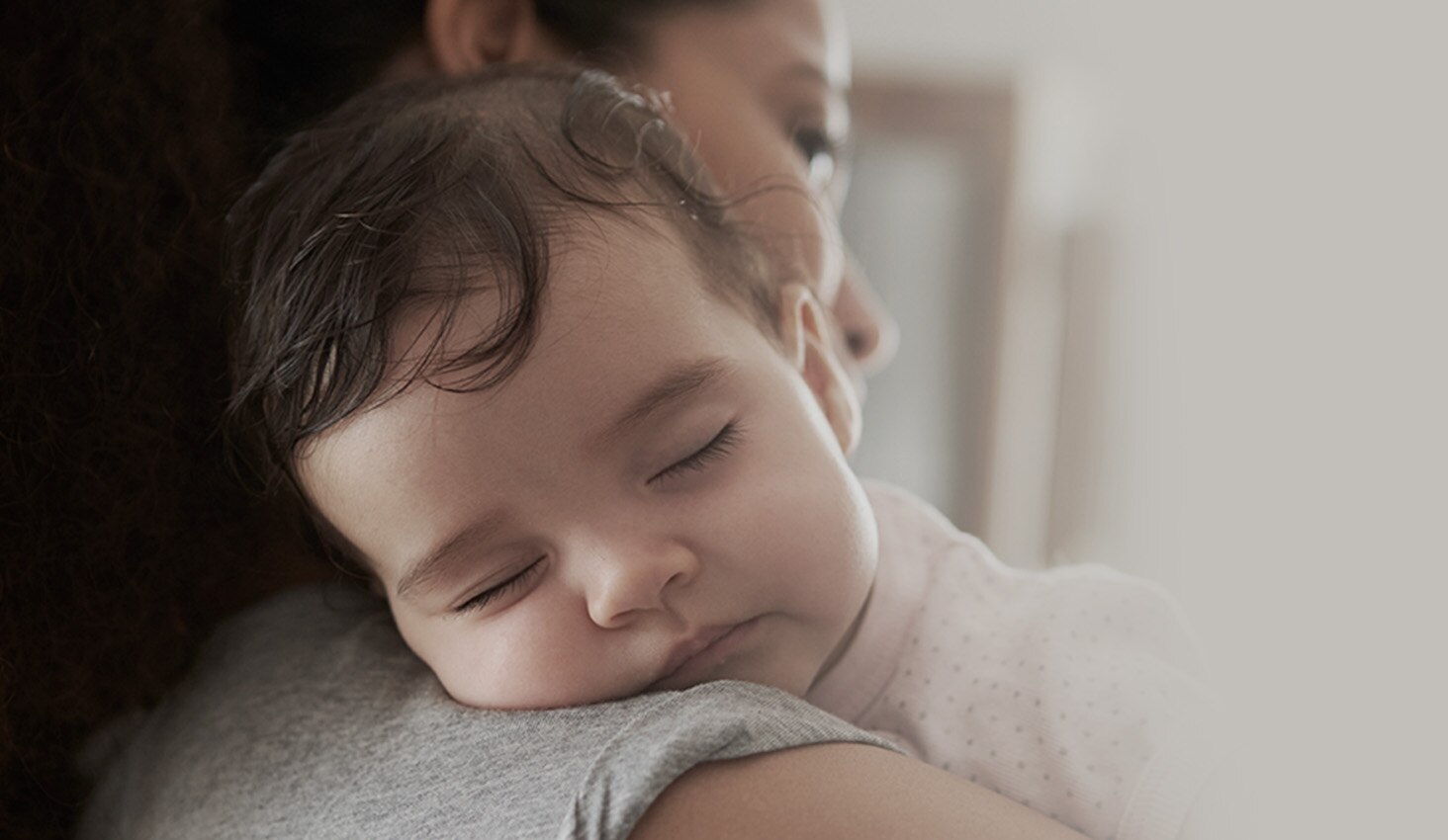 Bebé durmiendo en el hombro de mamá